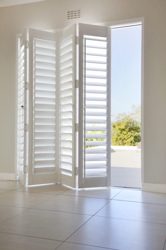 Aluminium bi-fold pvc shutters installed in lounge door